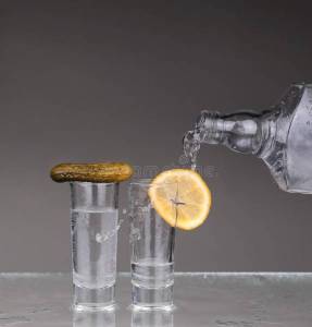 vodka-poured-glass-vodka-poured-glass-over-grey-background-124360656.jpg